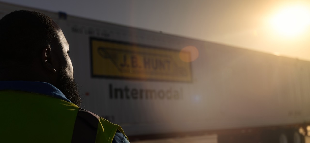 Driver looking into sunset with j.b. hunt intermodal truck in background