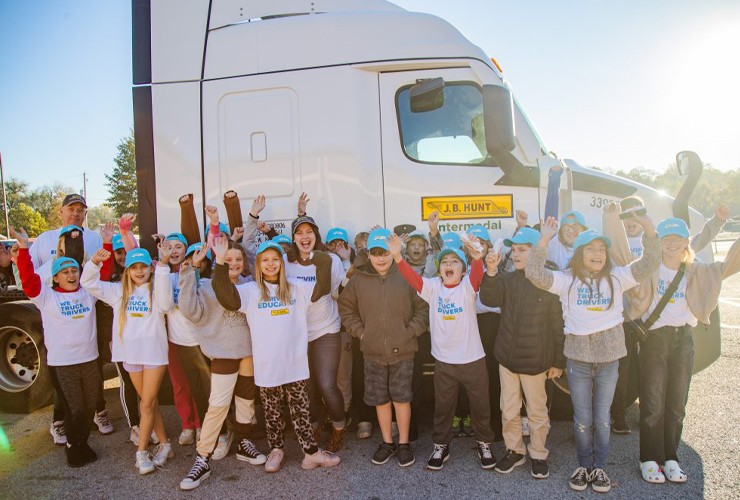 Adopt a class students standing in front of a J.B. Hunt truck
