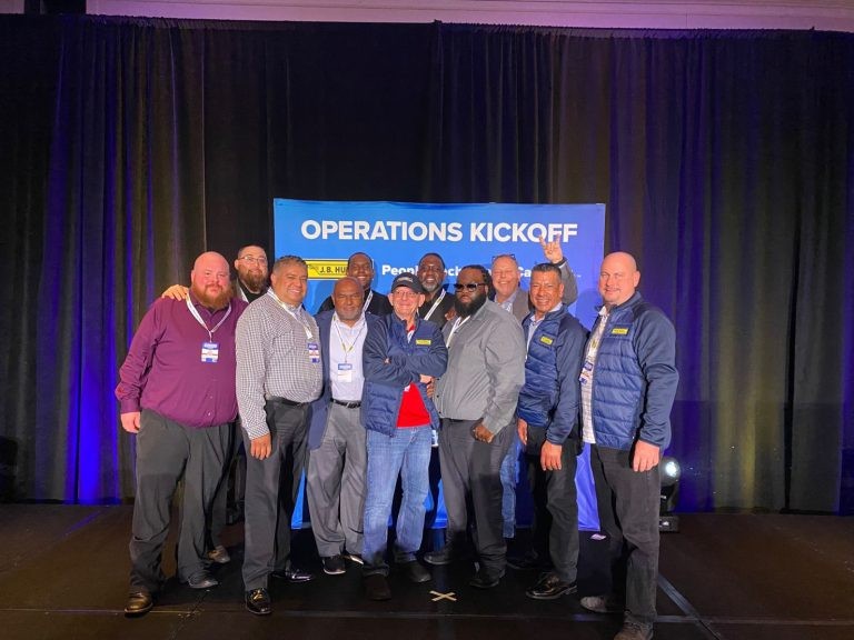 Group photo of J.B. Hunt drivers and managers at a kickoff celebration.
