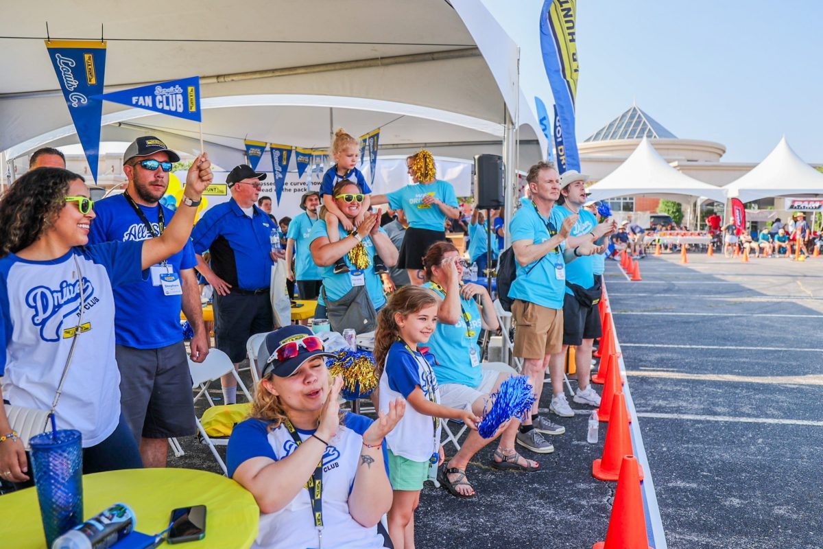 Crowd stands and cheers for J.B. Hunt drivers competing in the Arkansas Trucking Competition.
