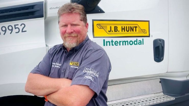 adam posing with his truck after winning Goodyear's Highway Hero Award