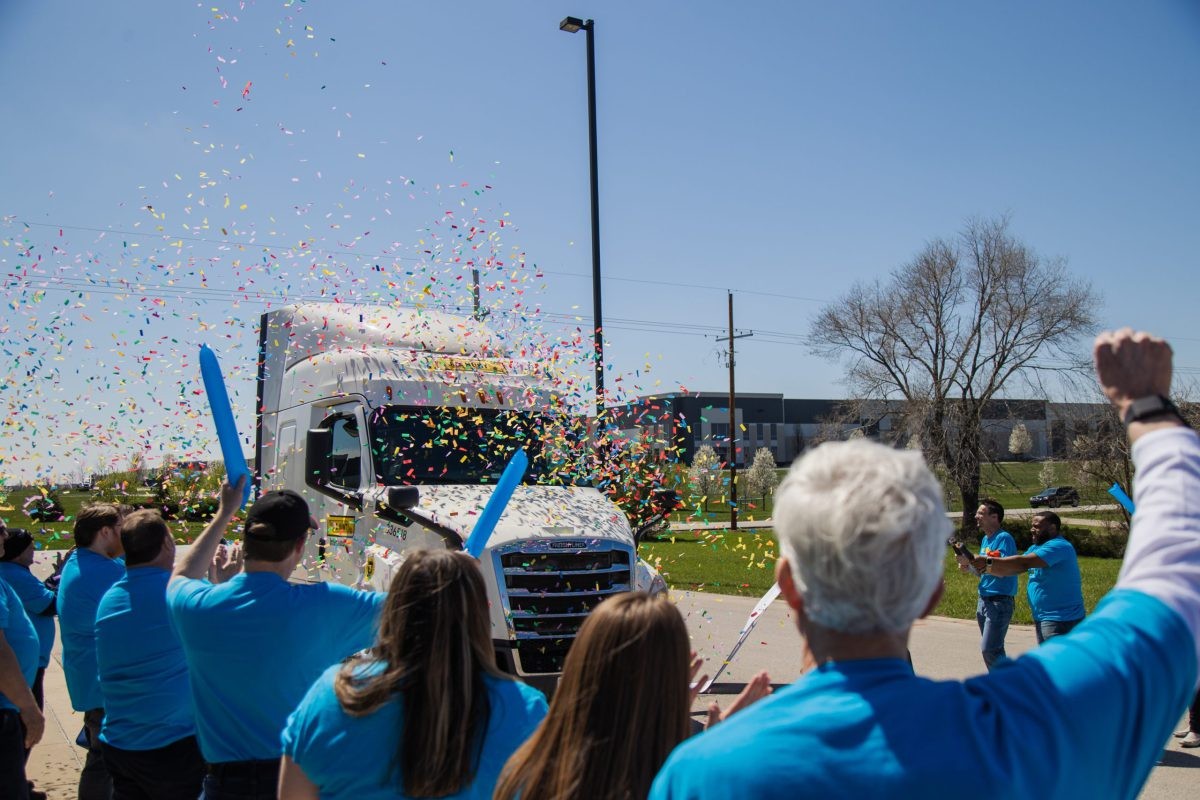 J.B. Hunt 5 million mile driver drives next to cheering crowd and confetti at his million mile celebration.
