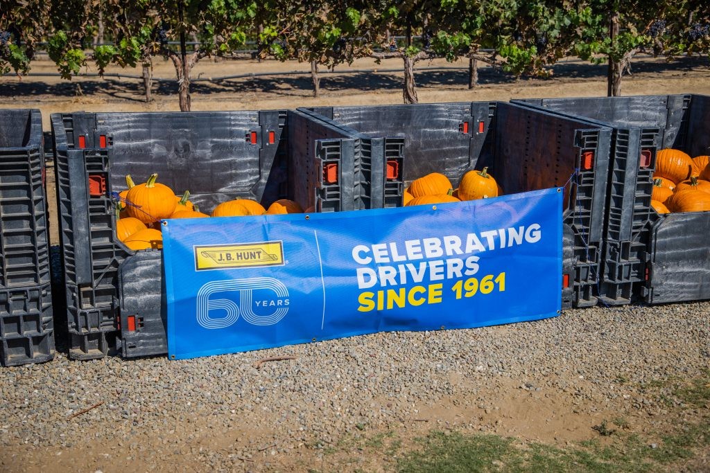 Pumpkin cartons with a J.B. Hunt driver celebration banner attached to the front.