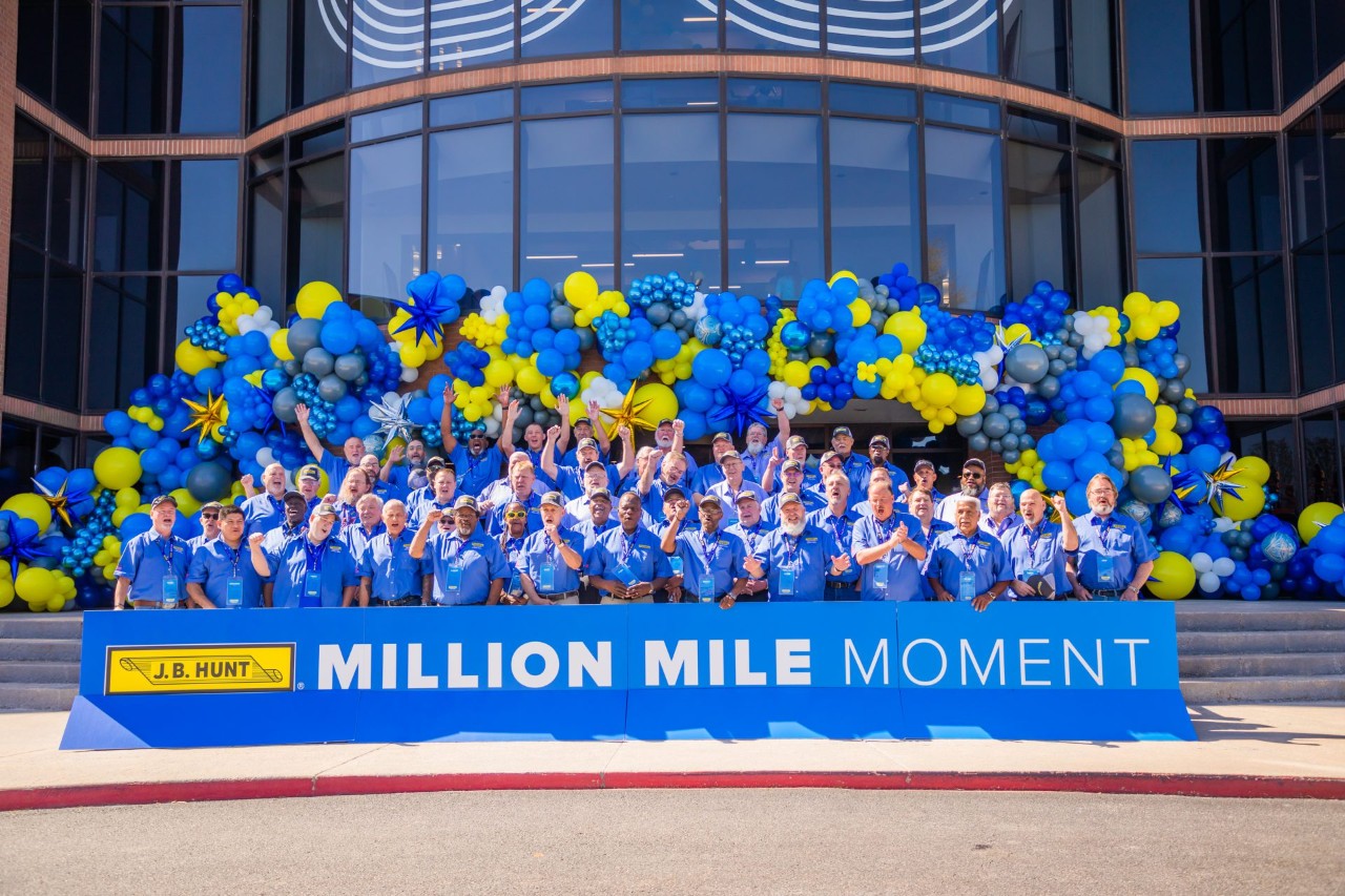 J.B. Hunt million-mile drivers stand in a group for a photo at the company corporate headquarters.