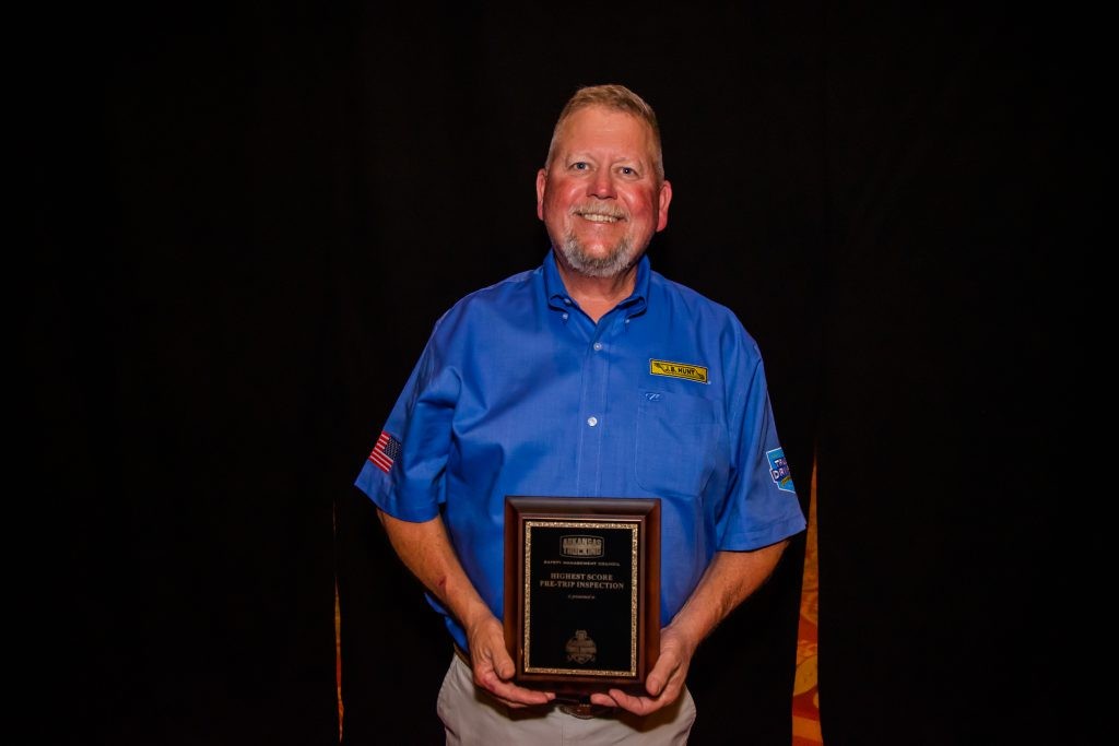 J.B. Hunt driver James holds his award for Highest Written Score.