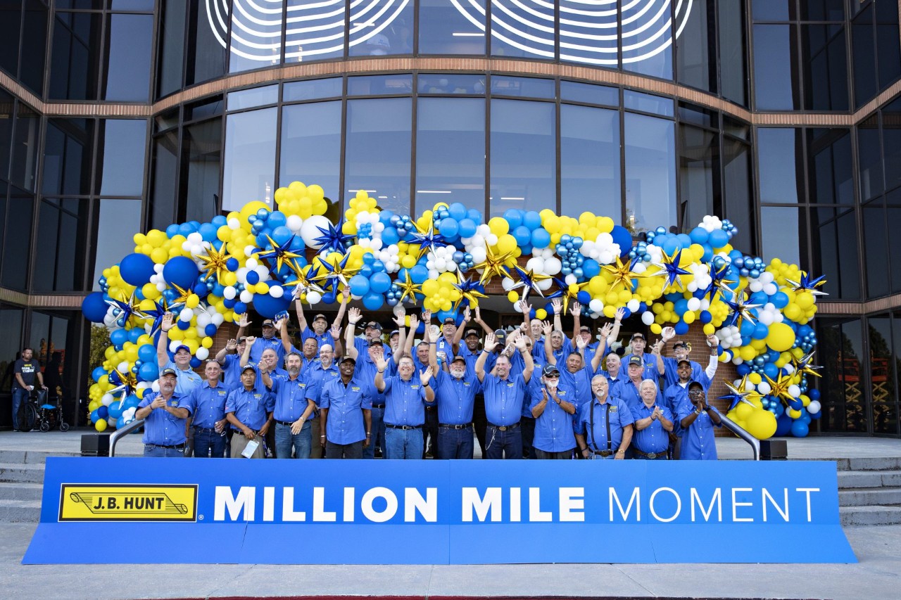 The 2021 Million Mile drivers standing outside of the J.B. Hunt corporate campus celebrating.