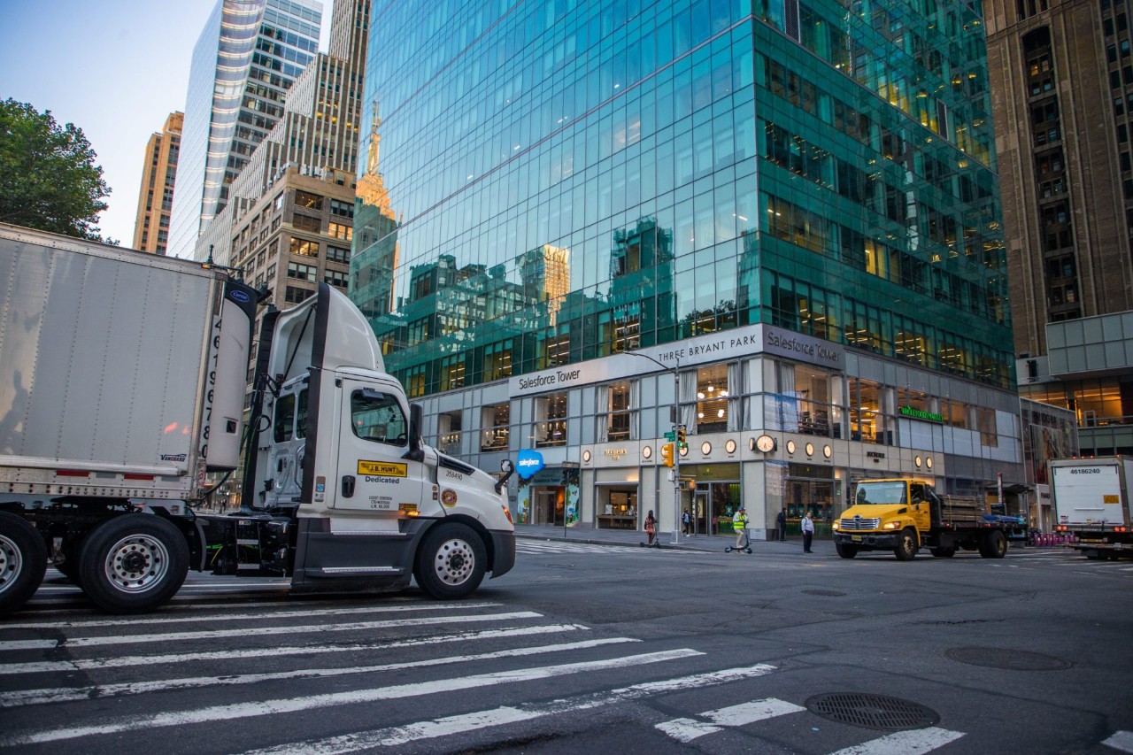 J.B. Hunt Dedicated truck and trailer driving through a metropolitan city intersection.