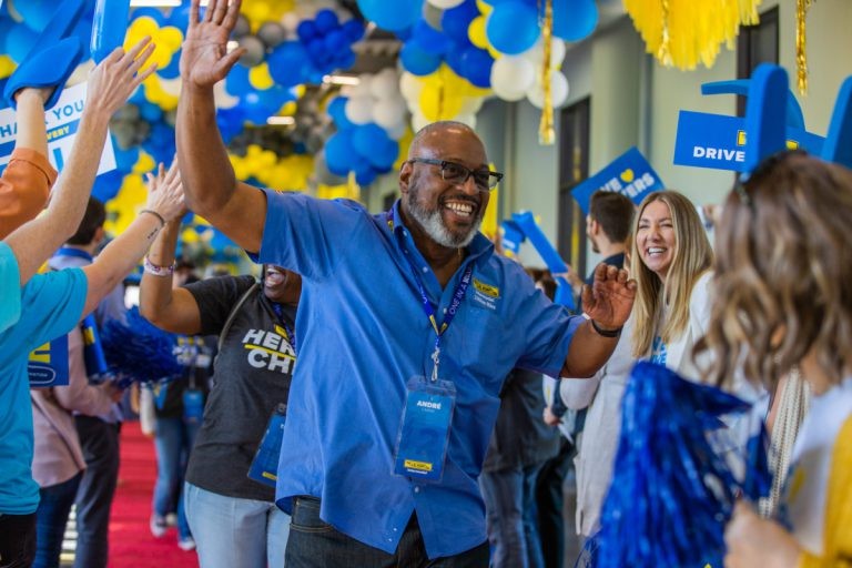 J.B. Hunt driver walks down red carpet and gives a high five during million mile celebration.