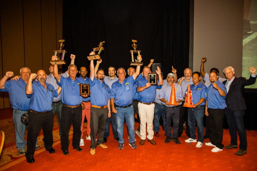 J.B. Hunt drivers cheer with their awards alongside CFO Craig Harper.