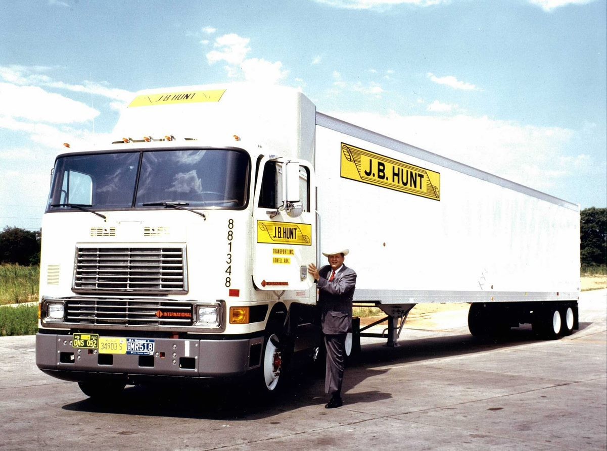 Mr. Hunt opening the door of a J.B. Hunt branded cabover truck and trailer.