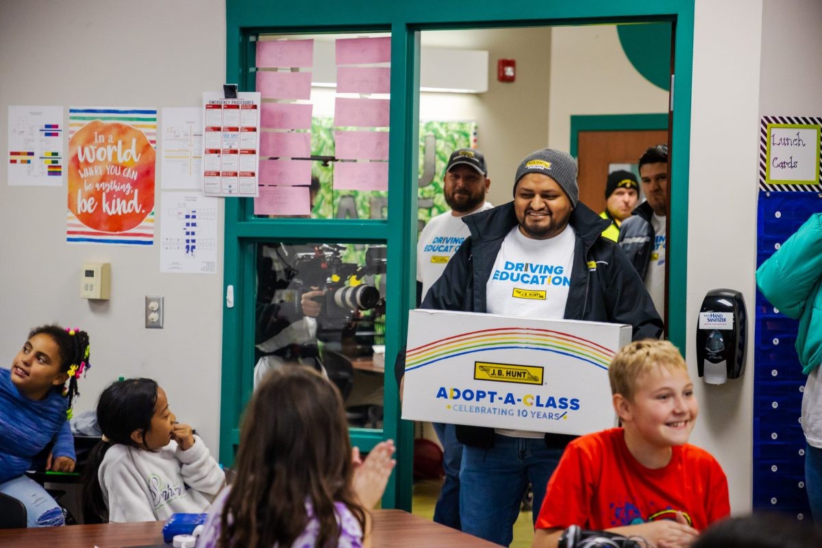 J.B. Hunt driver delivers box of classroom donations to his daughter's school.