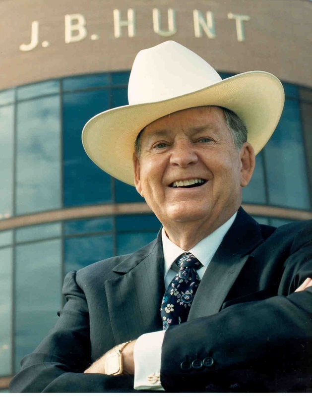 Mr. Hunt standing in front of the corporate office with arms crossed and smiling.