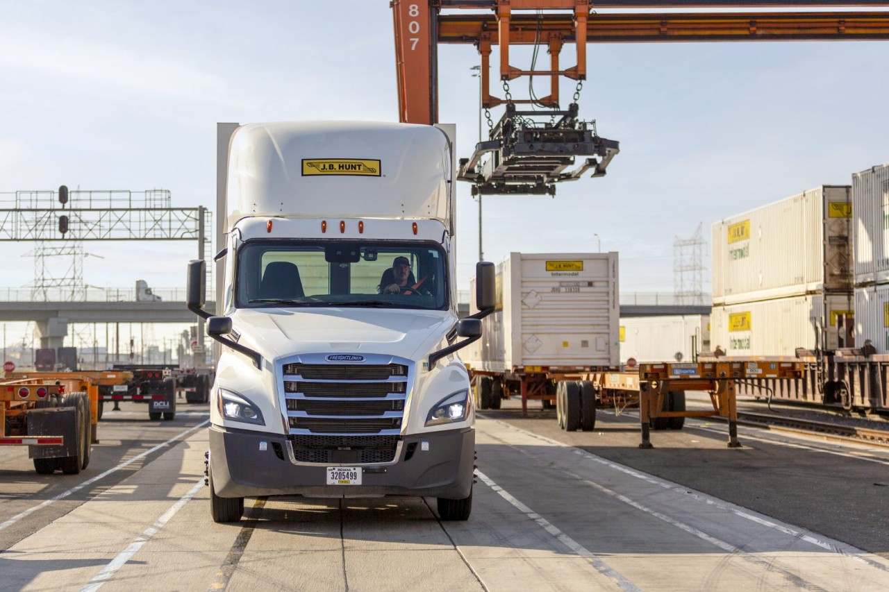 J.B. Hunt Intermodal driver in truck driving through a transloading facility.