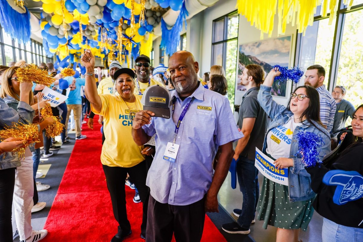 2 million mile J.B. Hunt driver walks a red carpet and gives high fives to cheering crowd.