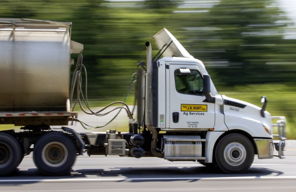 J.B. Hunt Ag Services day cab hauling dry feed.