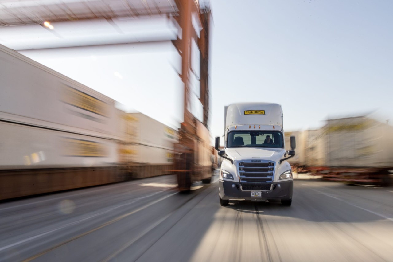 A J.B. Hunt Intermodal truck driving through a transload facility
