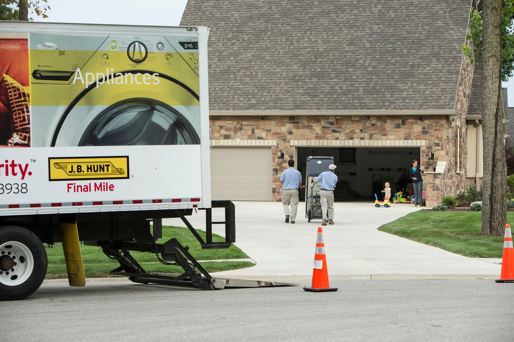 Delivery Installation Specialists unload Final Mile Services truck for home delivery. 