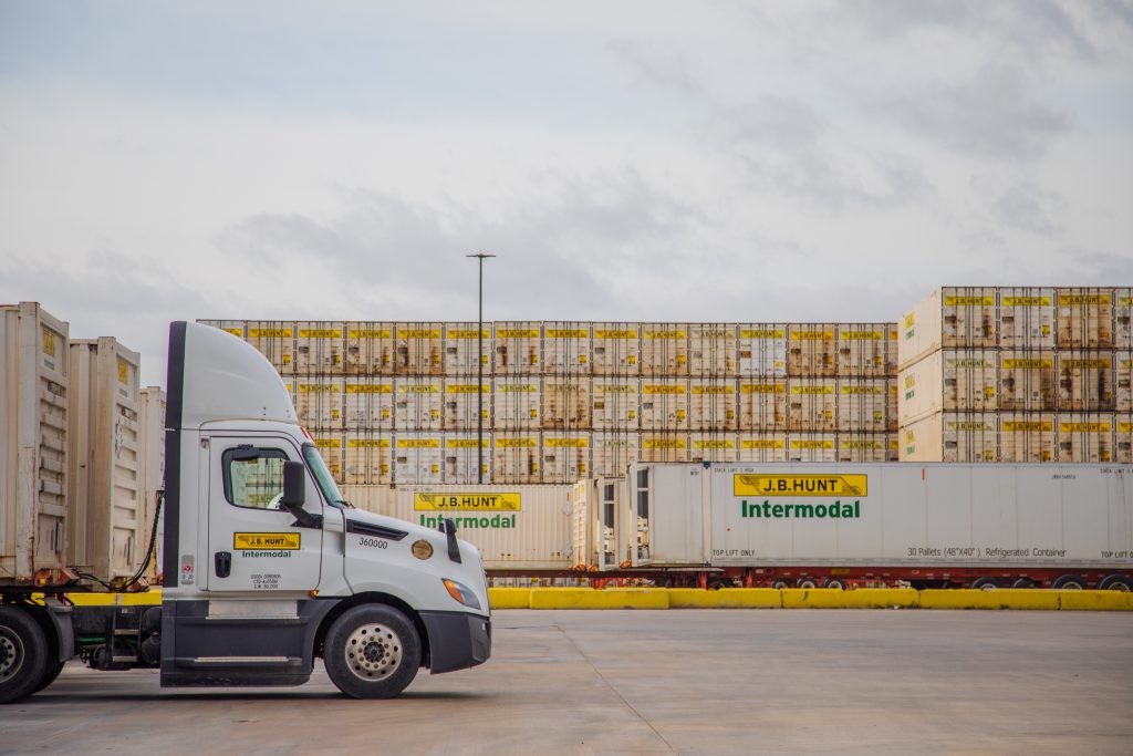 J.B. Hunt Intermodal truck parked in front of J.B. Hunt Intermodal containers.