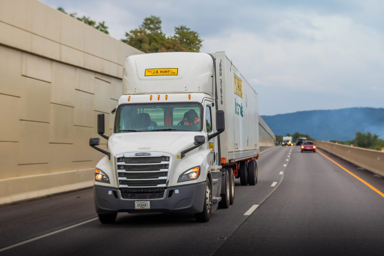 J.B. Hunt Intermodal truck and trailer driving down a highway.