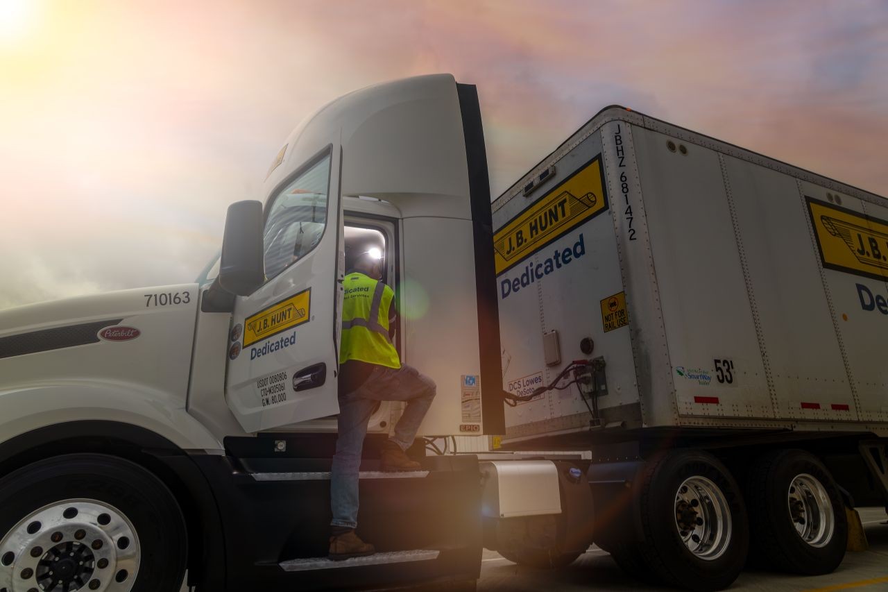 J.B. Hunt Dedicated Contract Services driver getting in his truck