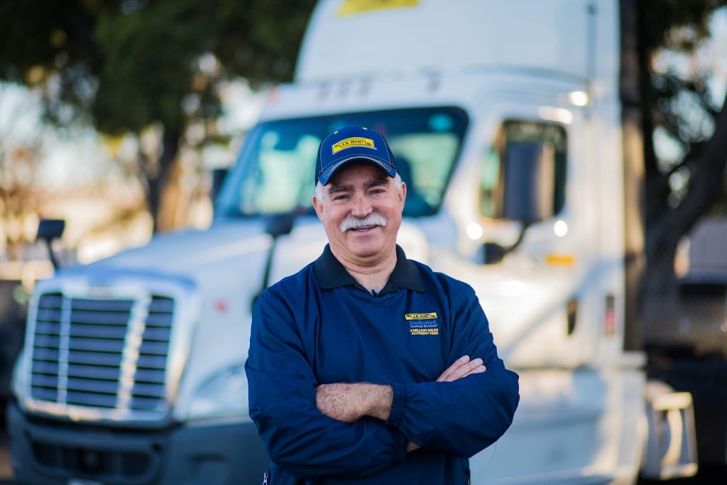 Dedicated driver Juan standing in front of J.B. Hunt day cab.