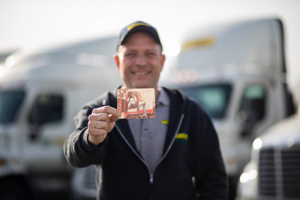 Intermodal driver Kevin poses with old photo of his father. 