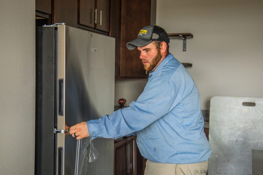 Final Mile driver Brad installing a refrigerator.