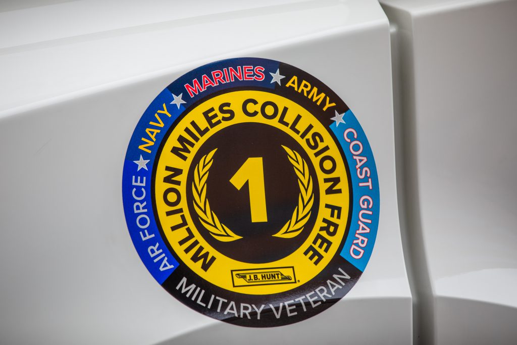 Image of million mile and veteran decal on white truck.