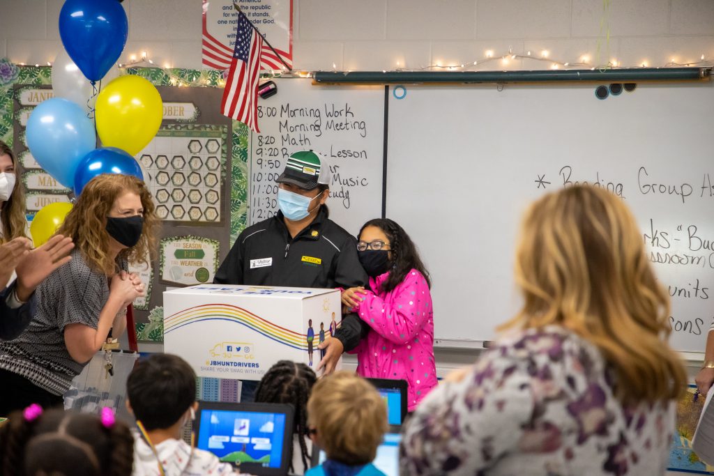J.B. Hunt driver Ray delivers school supply donation to his daughter's classroom.