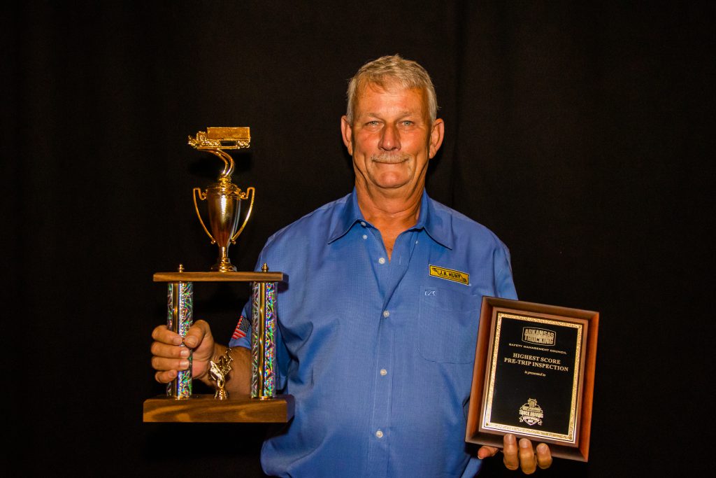 J.B. Hunt driver Darrell holds his awards for Highest Pre-Trip Score and Third Place in Sleeper Division.