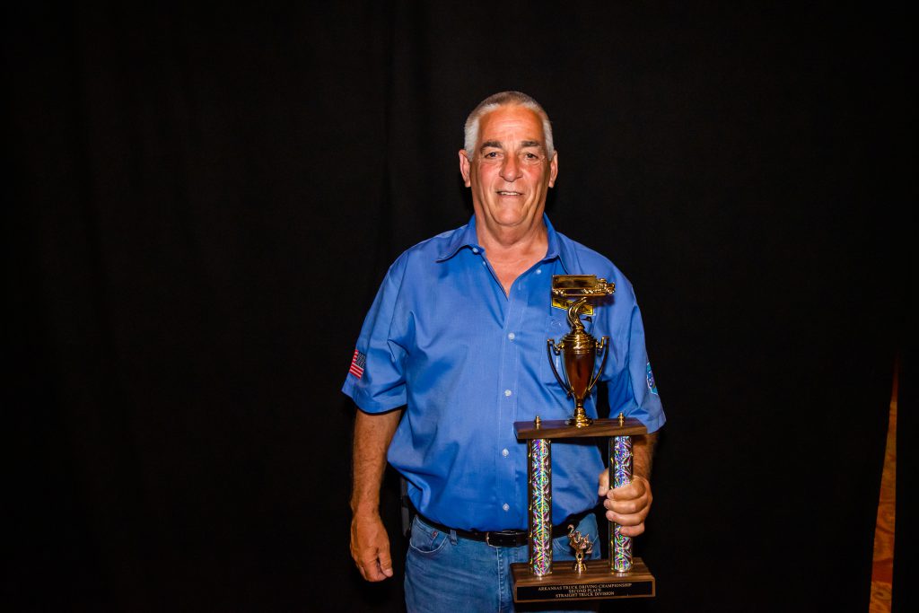 J.B. Hunt driver Dale holds his award for Second in Straight Truck Division.