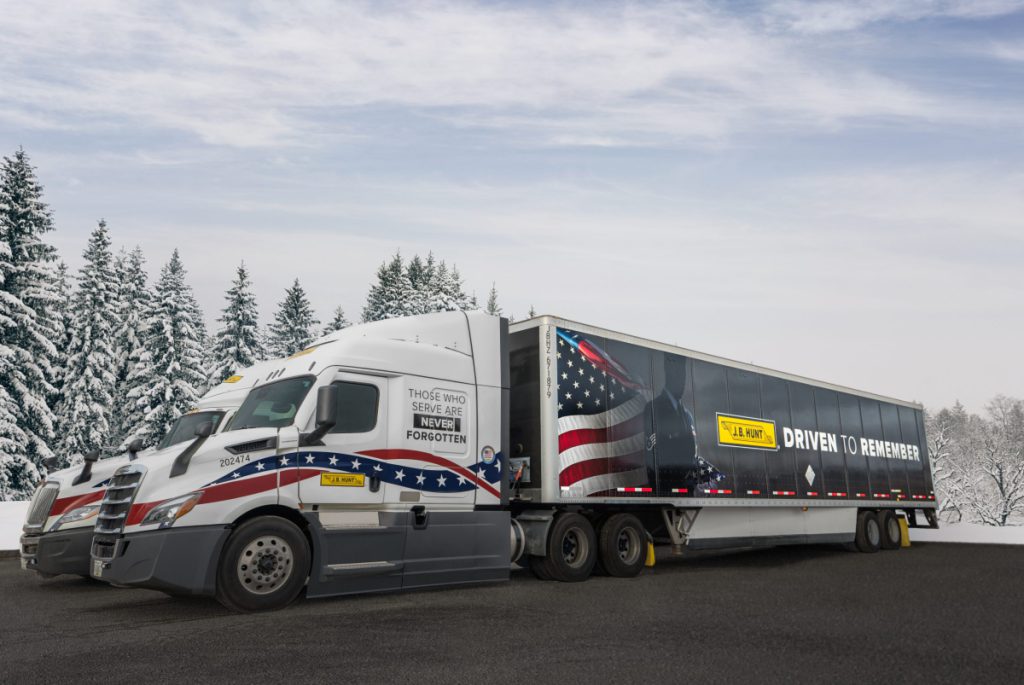 Two J.B. Hunt trucks and trailers wrapped for the Wreaths Across America 2022 convoy.
