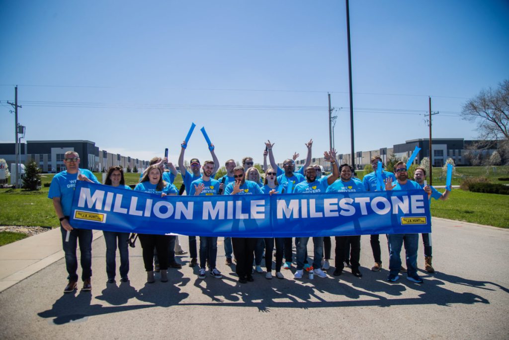 J.B. Hunt employees cheering and holding banner that reads million mile moment.