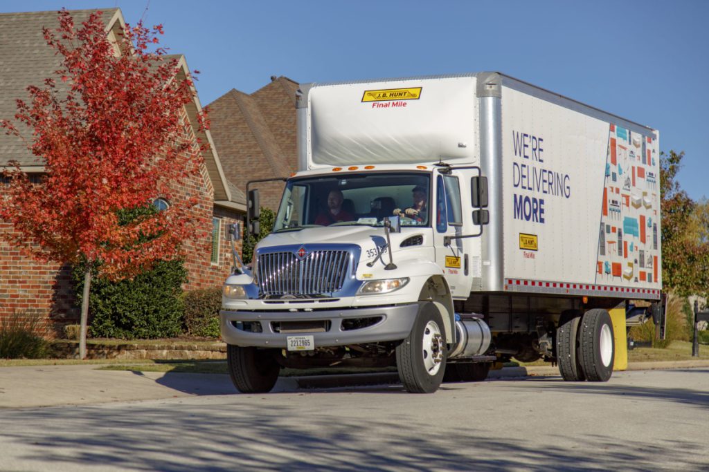 J.B. Hunt Final Mile Services box truck drives down residential street.