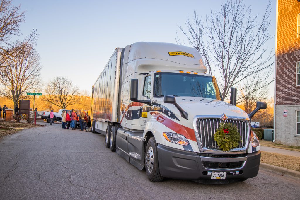 J.B. Hunt truck hauling wreaths is unloaded at a national cemetery.
