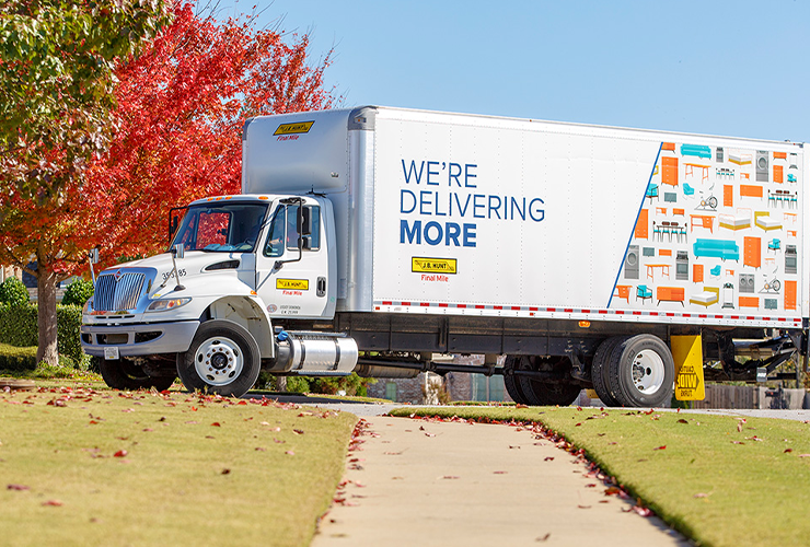 Final mile box truck parked in a neighborhood during a fall day