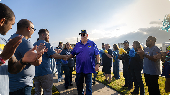 driver gets applause and handshakes for driving many safe miles
