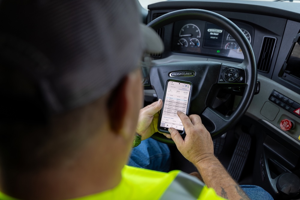 Driver looking at his phone while in the cab of a truck