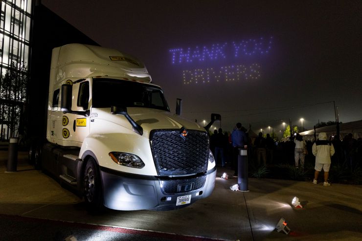 J.B. Hunt truck at night with drone show in the background