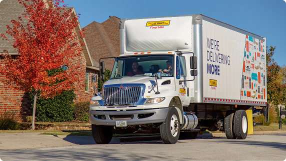 An FMS truck in a neighborhood with fall foliage