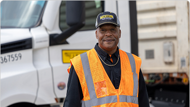 local driver posing in front of truck