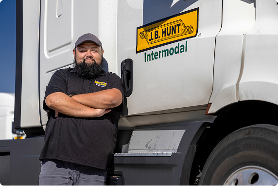 Regional intermodal driver standing next to his truck