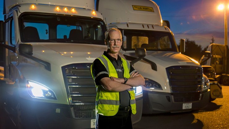driver in front of trucks at night