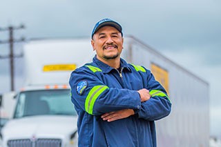 J.B. Hunt stands in front of a white j.b. hunt truck
