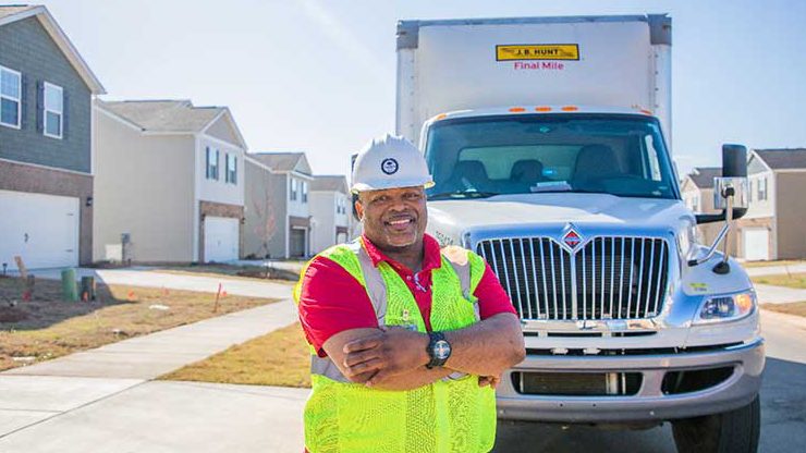 Final mile driver in front of box truck in a neighborhood