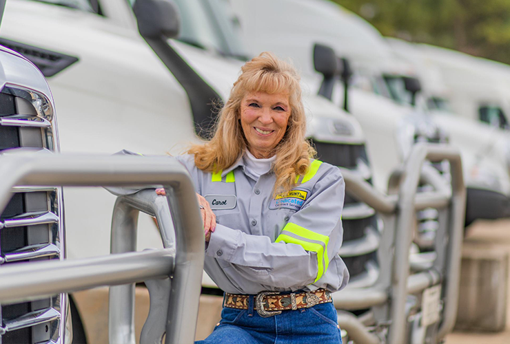 J.B. Hunt dedicated driver standing in front of truck